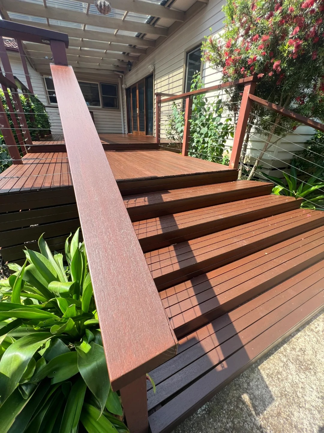 Restored outdoor timber deck steps and handrail