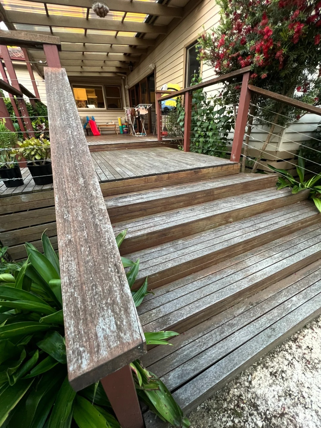 Weathered timber deck stairs before restoration