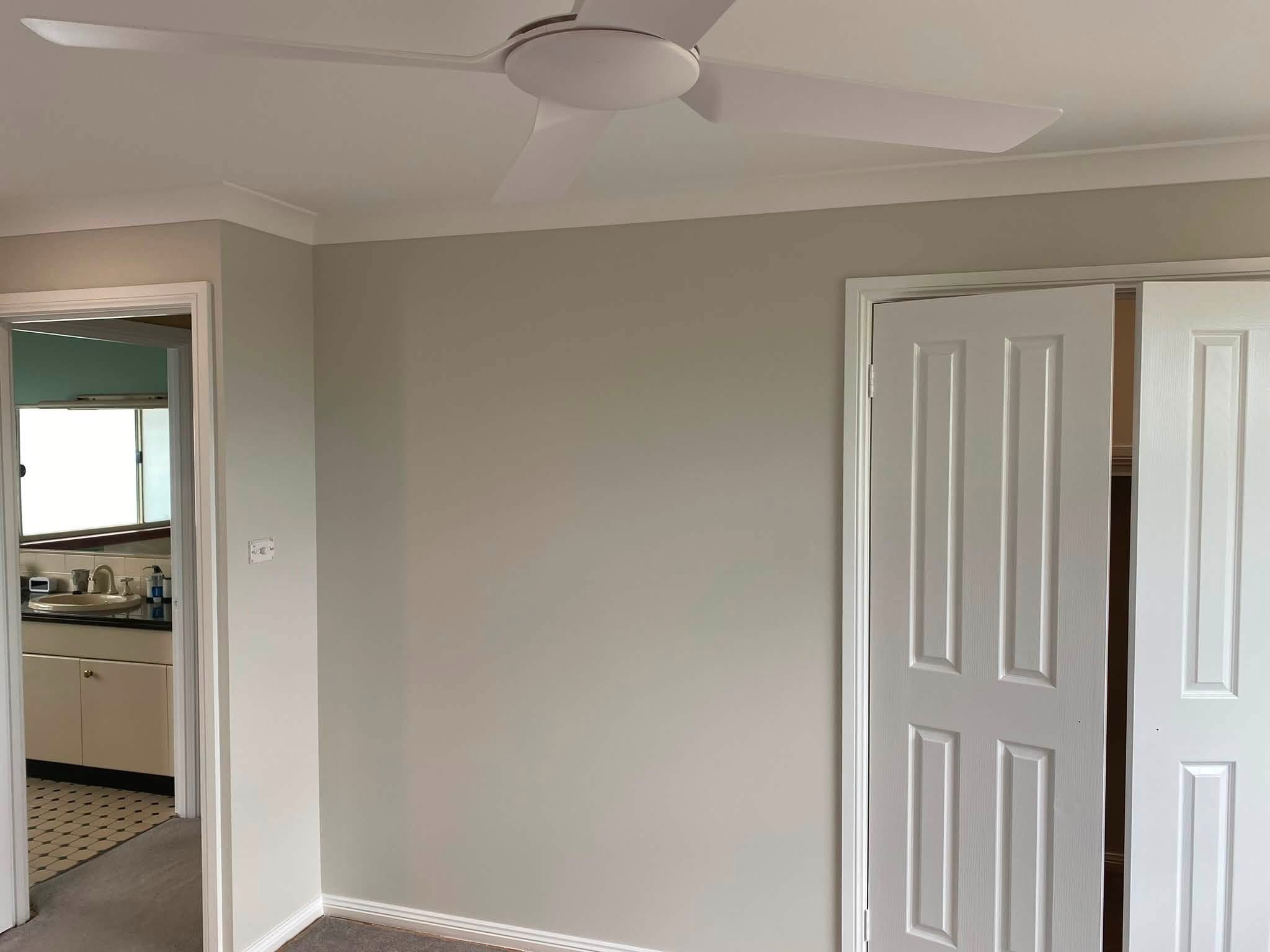 Finished bedroom wall with internal doors and white trim