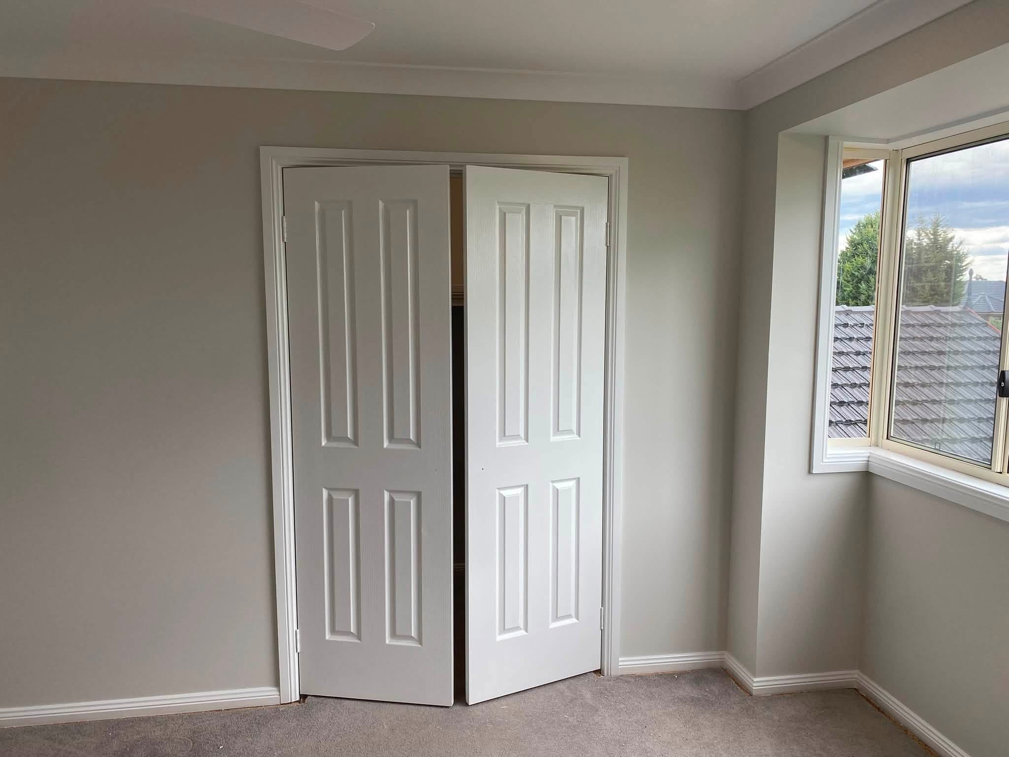 Finished internal doors, architraves and window trim in a bedroom