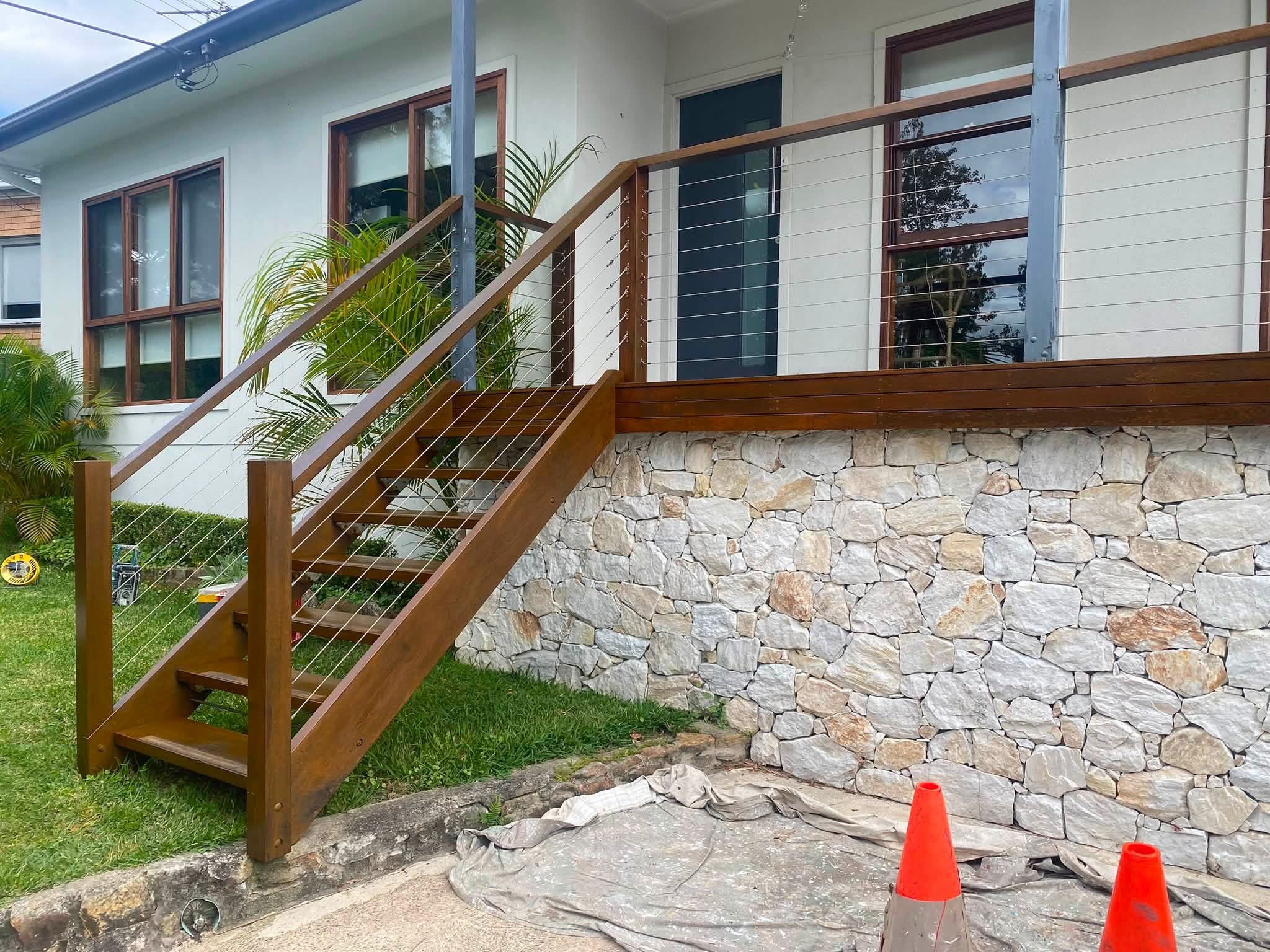 Completed timber windows, balcony handrail and outdoor stairs at a residential property